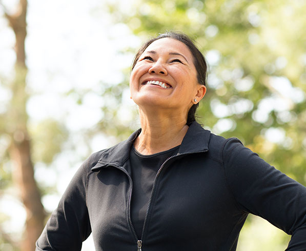 Middle-age woman smiling on a hike allergy free