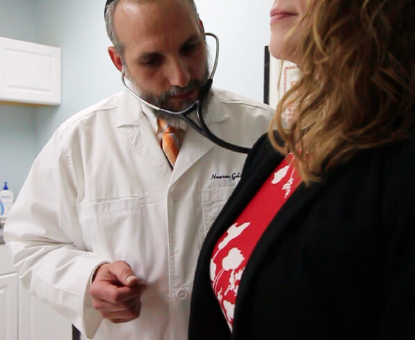 Dr. Nosson Goldfarb checking up a patient