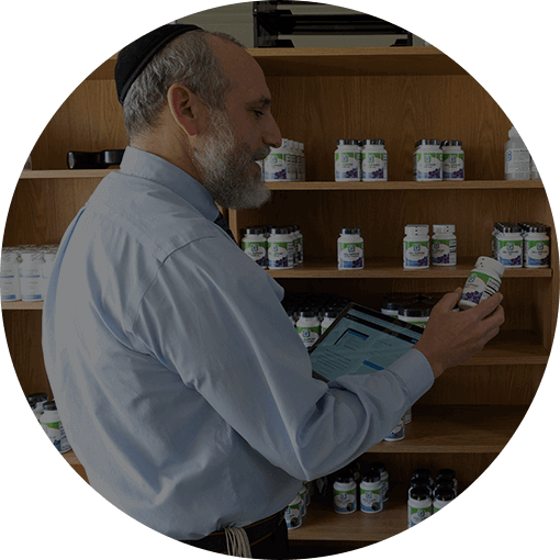 Dr. Nosson Goldfarb holding his own medicine products